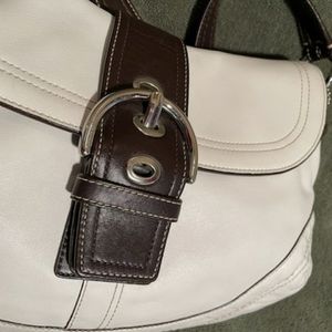Smaller white coach with brown trim purse